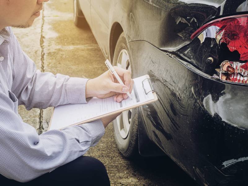 Insurance agent working on car accident claim process